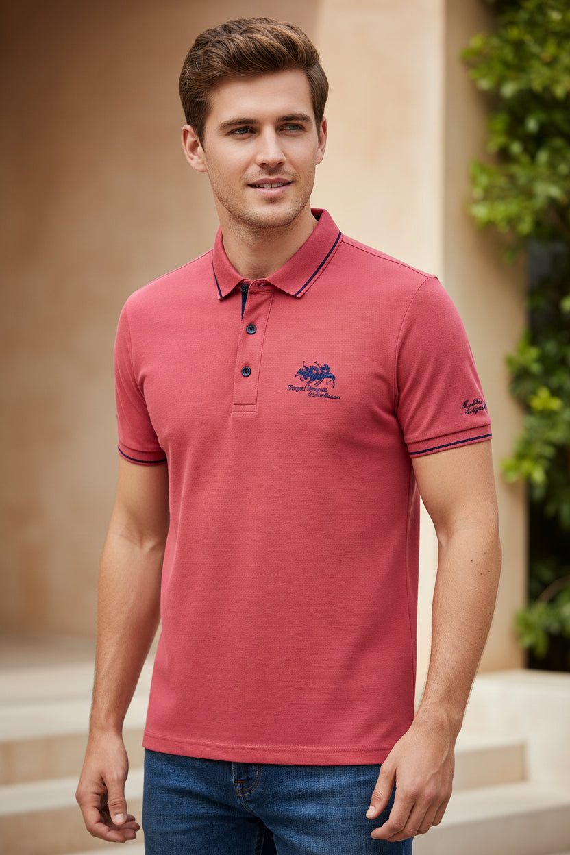 Folded red polo shirt with brand logo on a dark surface