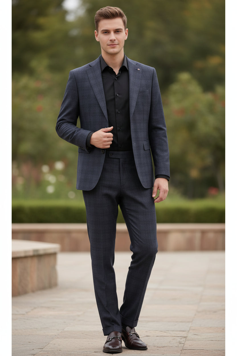 Gray suit with pants and shoes on a wooden surface.