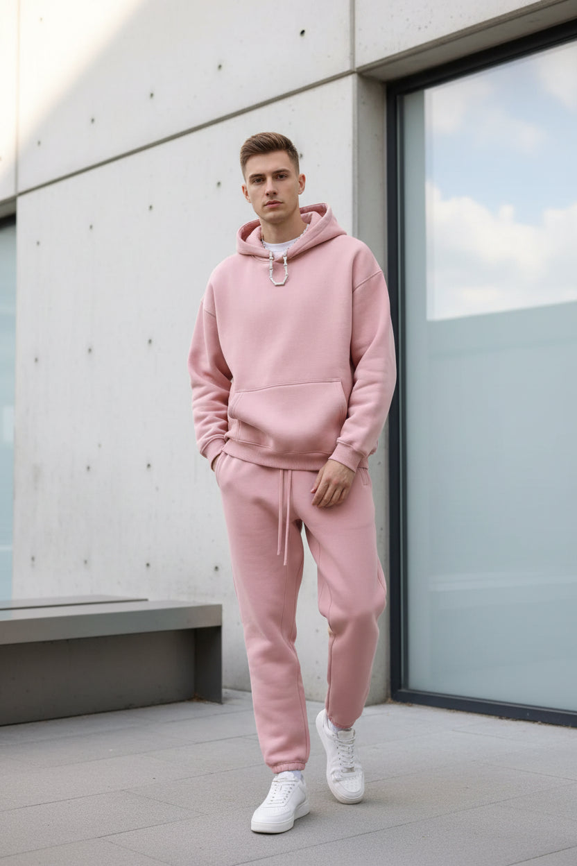 Person wearing a pink tracksuit on a white background
