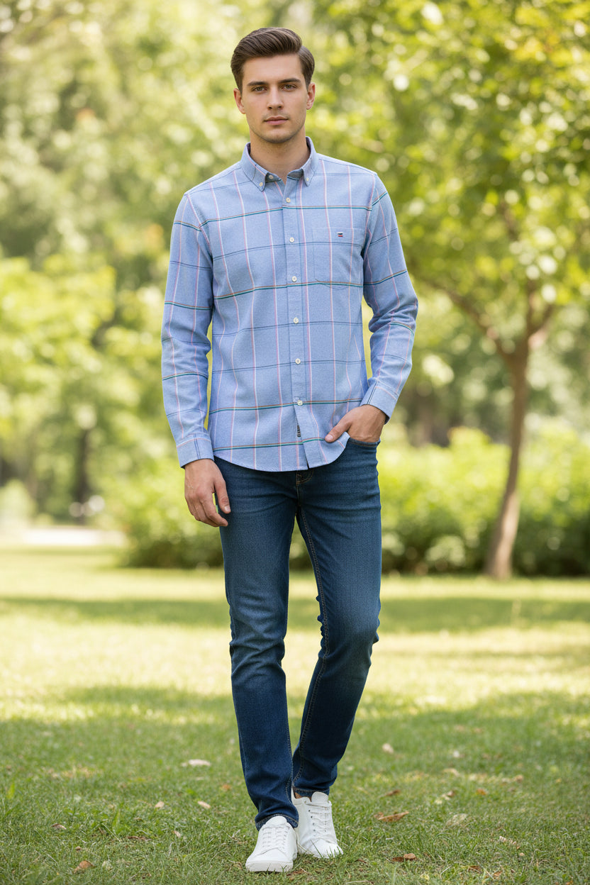 Folded blue checkered shirt with brand logo and text on a white background