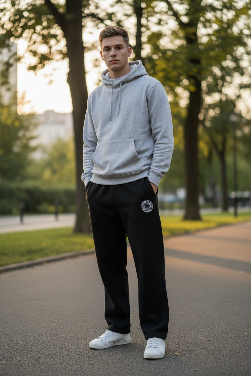 Black pants with a pocket on a gray concrete surface