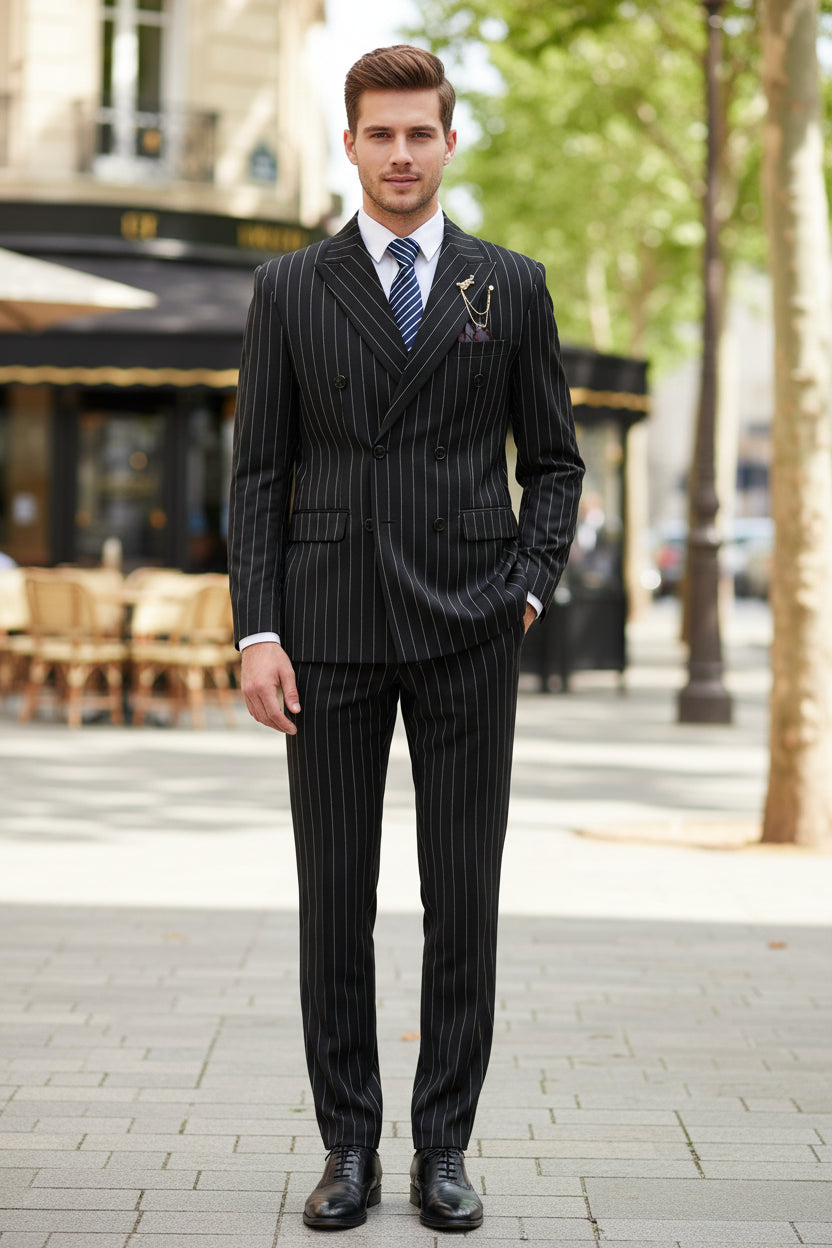 Black pinstripe suit with a blue tie on a mannequin against a gray background