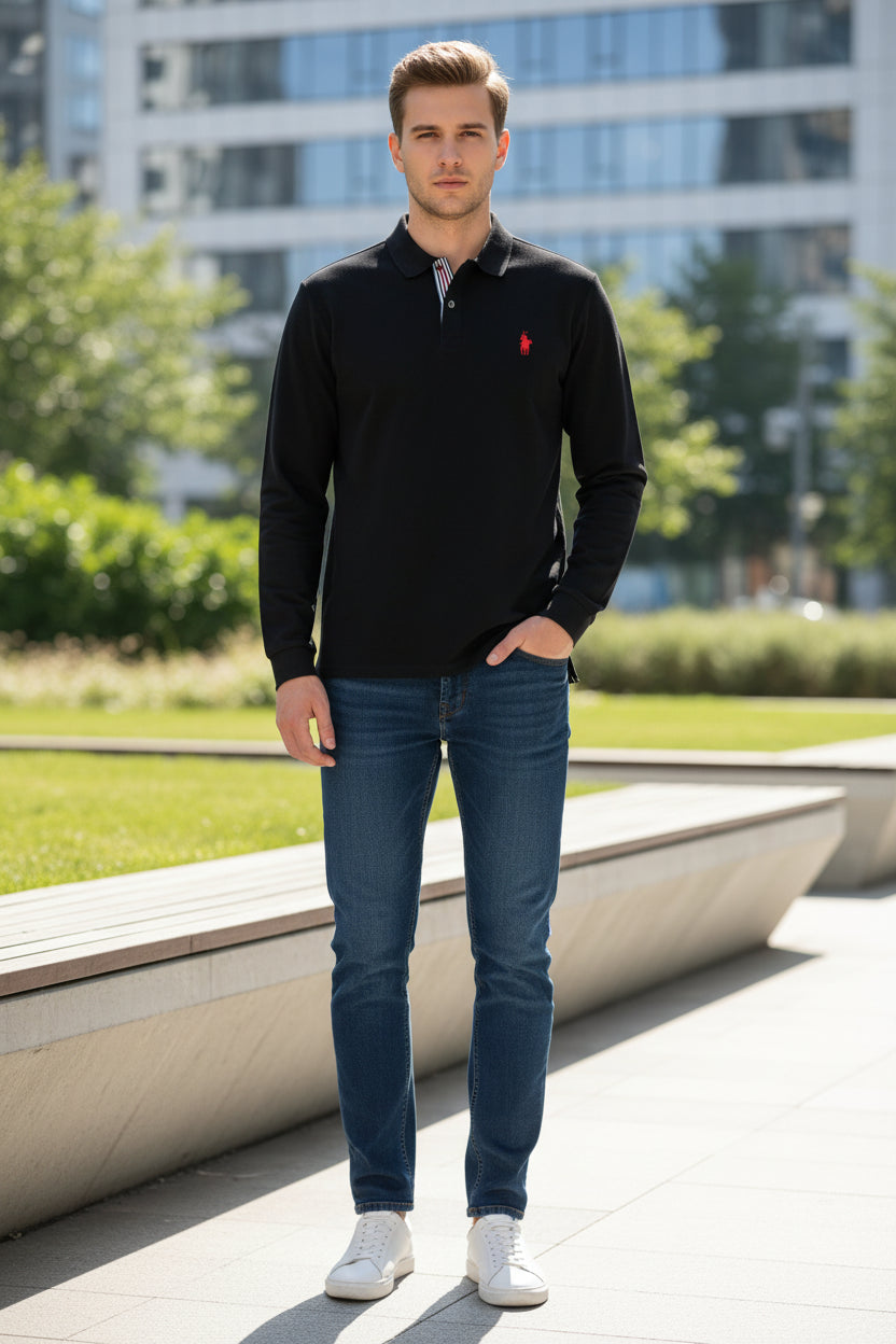 Black long-sleeve polo shirt with a red logo on a rack in a store.
