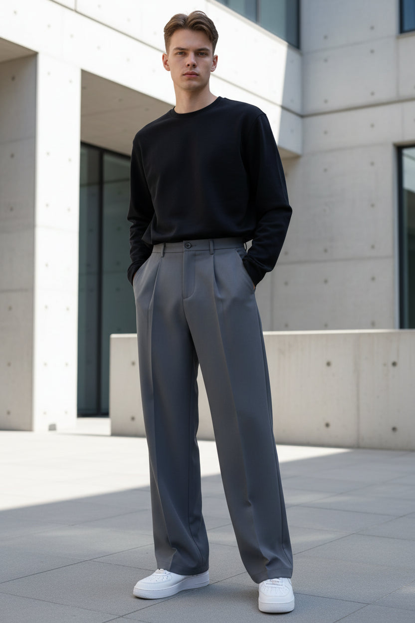 Person wearing gray pants and white shoes in a minimalistic setting