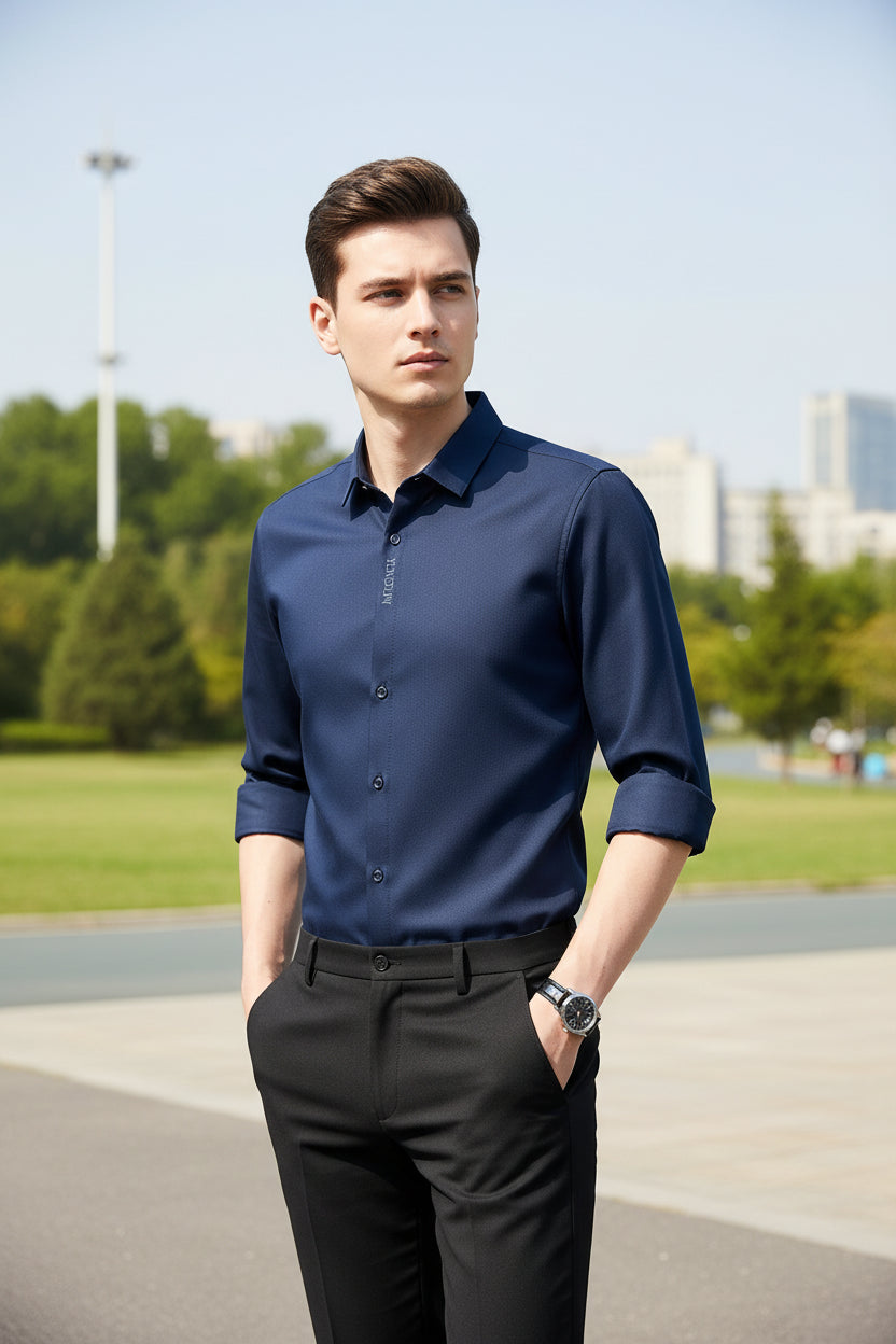 Navy blue dress shirt with rolled-up sleeves on a gray background