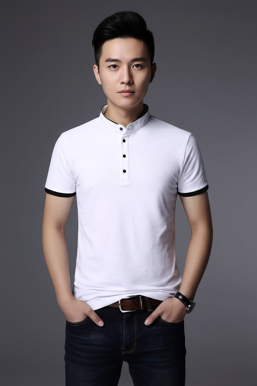 White polo shirt with black trim worn by a person on a gray background