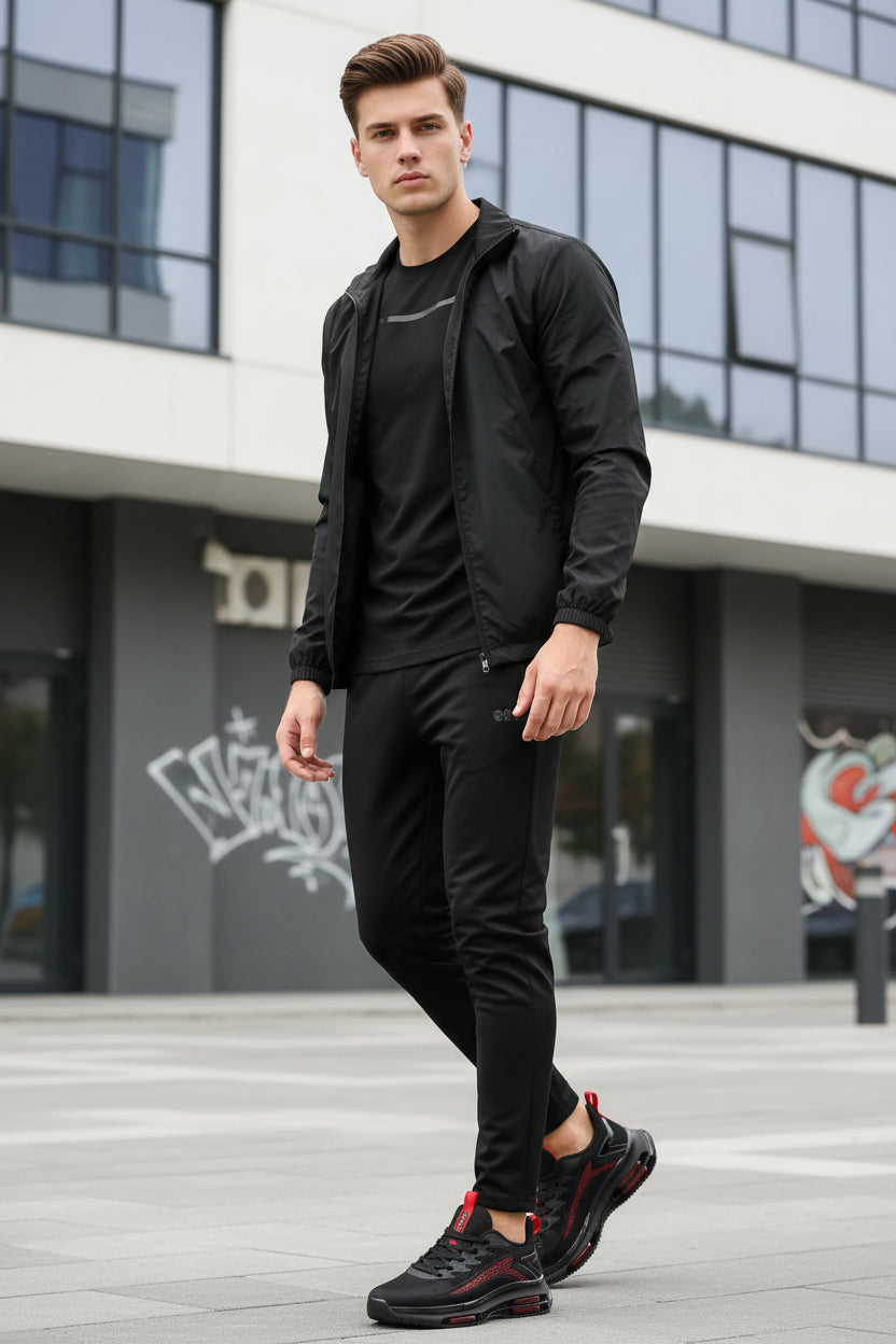 Black and red athletic shoes on a reflective surface with a gray background
