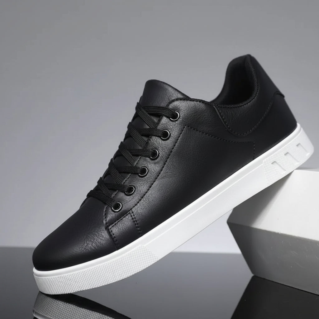 Black sneaker with white sole on a reflective surface