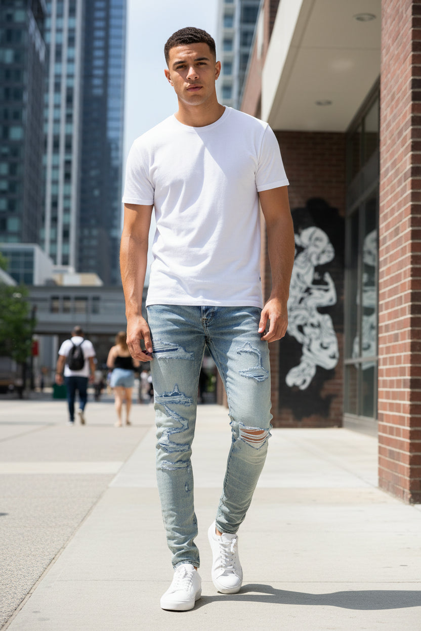Distressed blue jeans with a tag on a white background