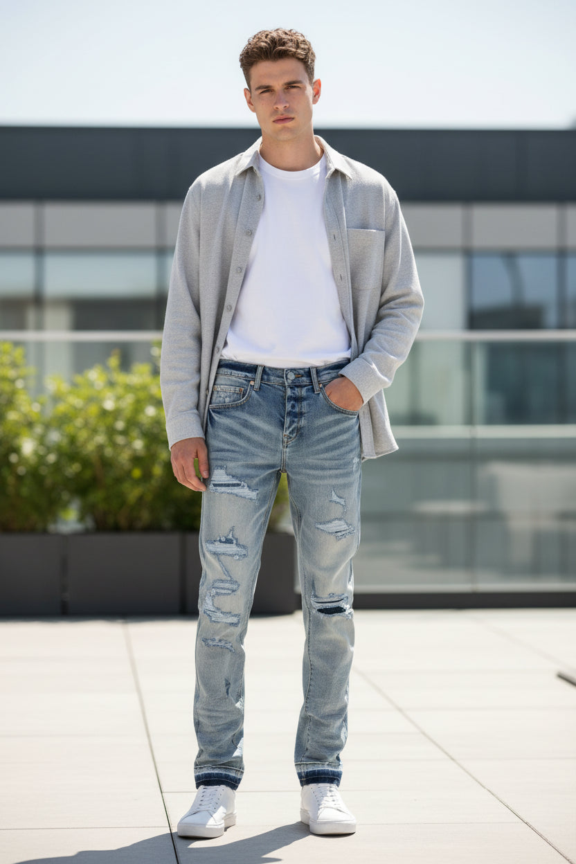 Pair of distressed blue jeans shown from front and back on a white background