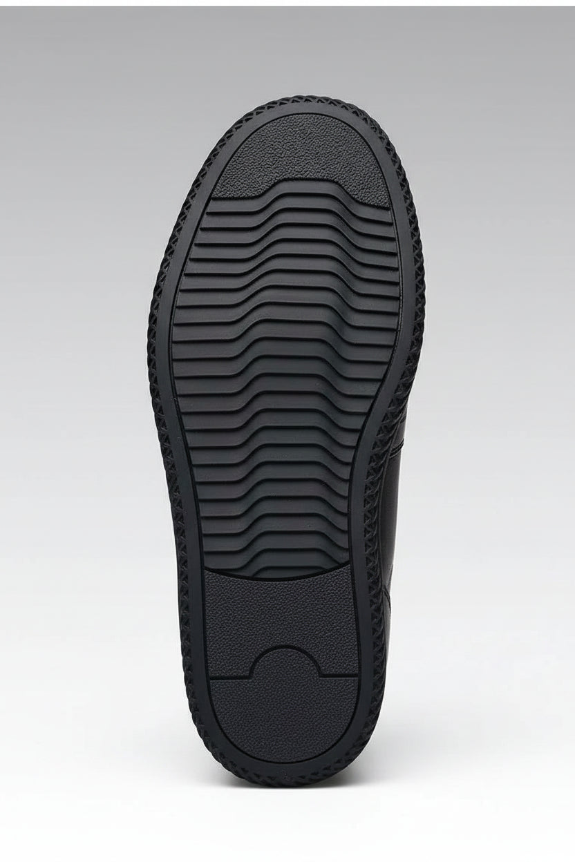 Close-up of a black rubber sole with text on a gray background