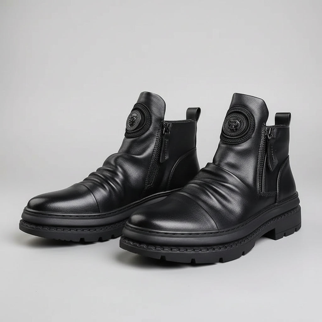 Pair of black leather boots with zippers on a dark background