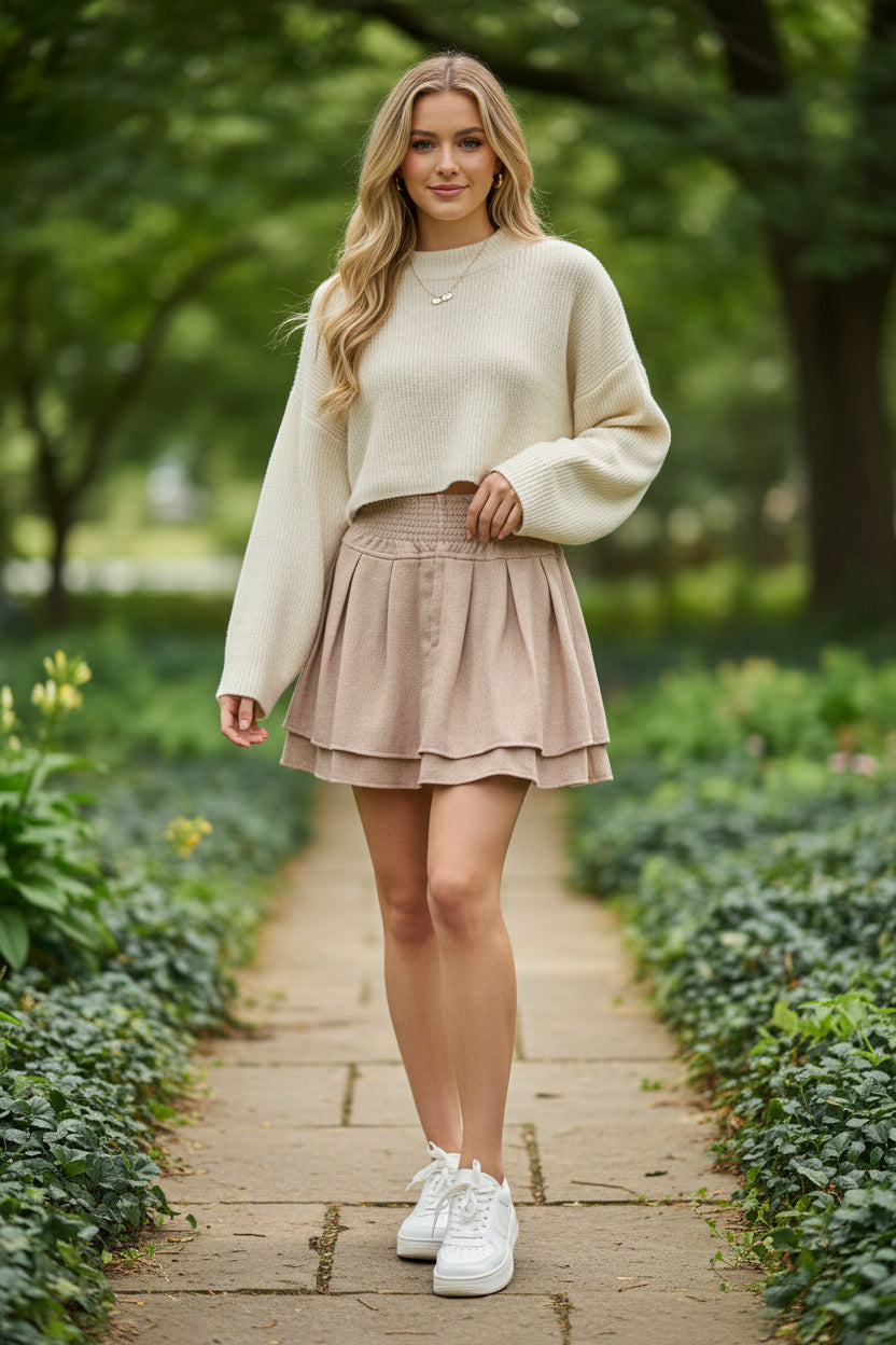 Beige skirt on a hanger against a gray background