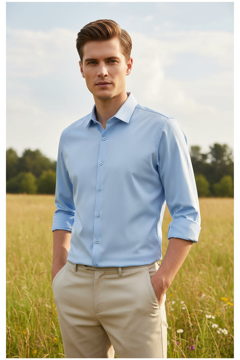 Light blue dress shirt with rolled-up sleeves worn by a person on a black background
