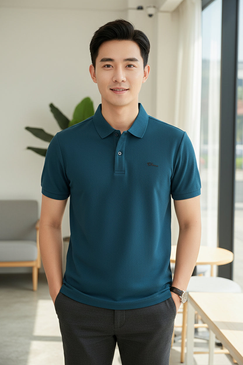 Blue polo shirt held by a hand with other shirts in the background
