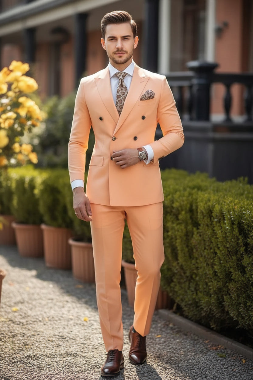 Man wearing a peach suit with a patterned tie and pocket square, standing outdoors.