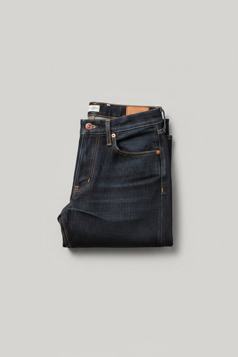 Person wearing dark jeans and black sneakers with a blurred background, featuring a 'Collocation' label.