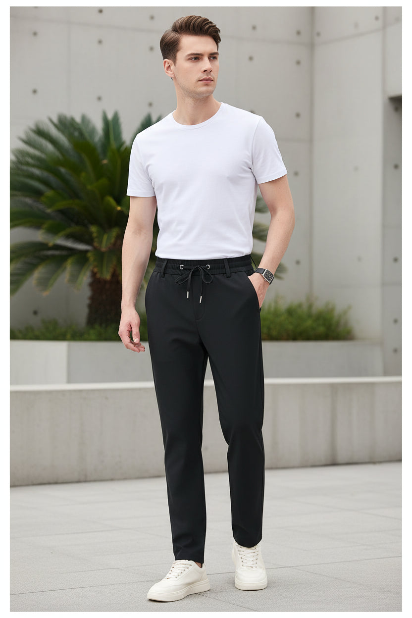 Black pants worn by a person on a white background