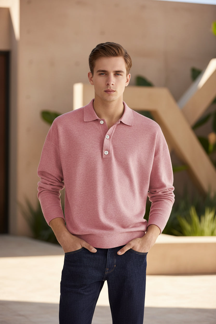 Person wearing a pink long-sleeve polo shirt against a beige background