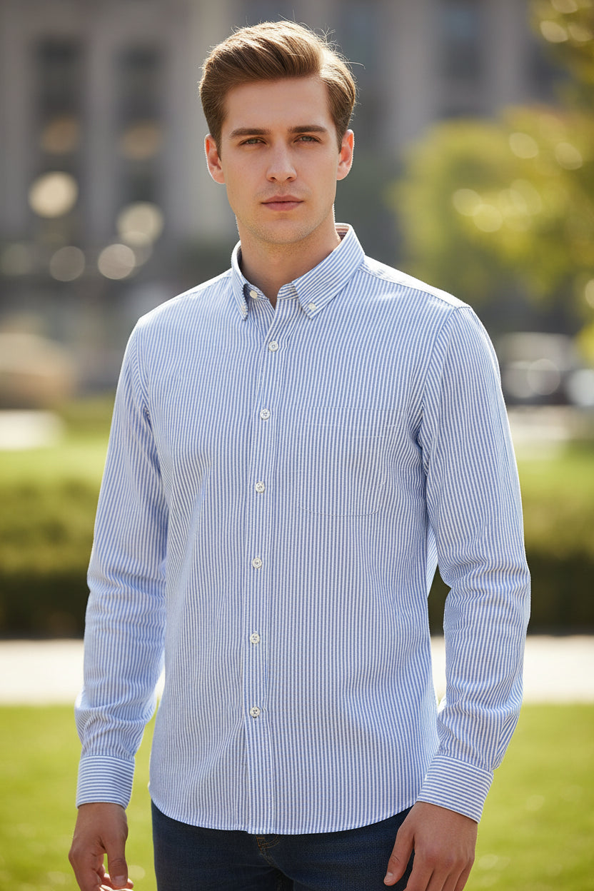 Folded blue and white striped shirt with close-up of fabric texture on a white background