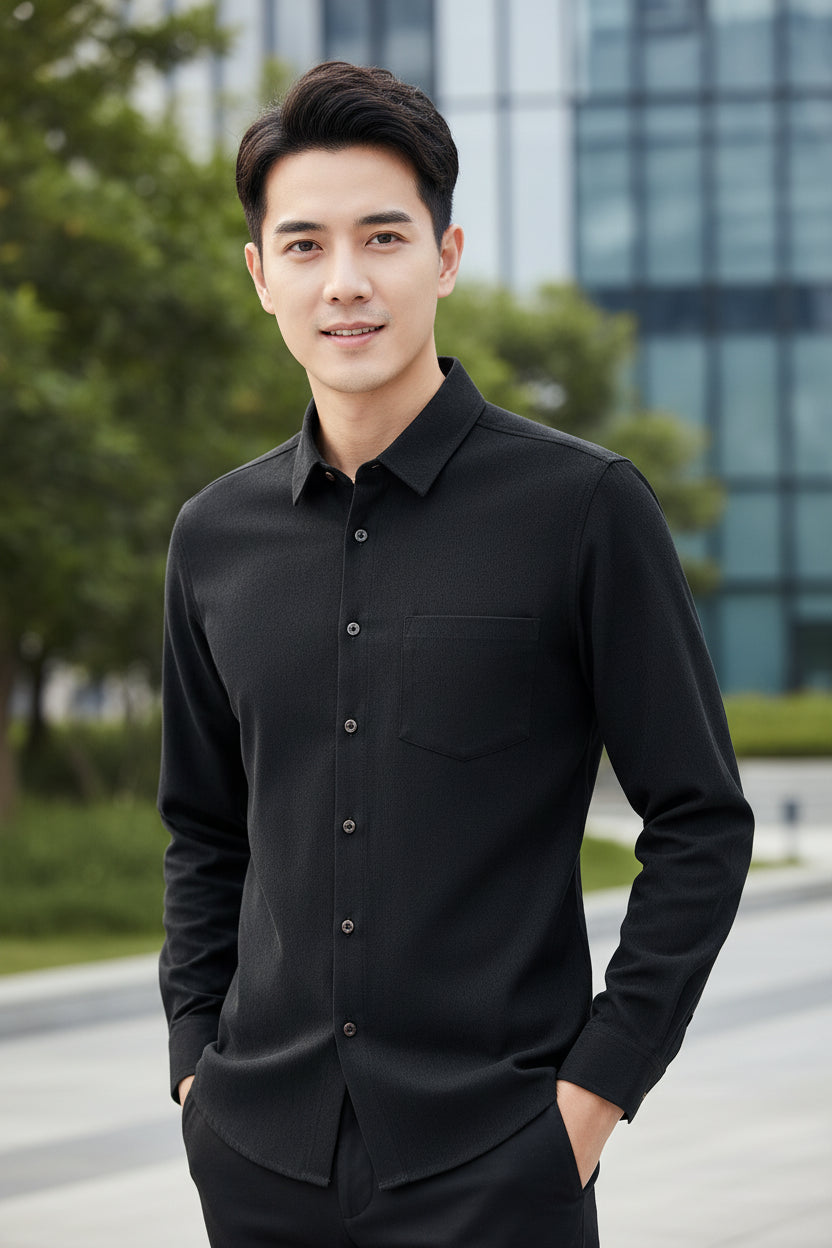 Black shirt on a wooden hanger against a gradient gray background