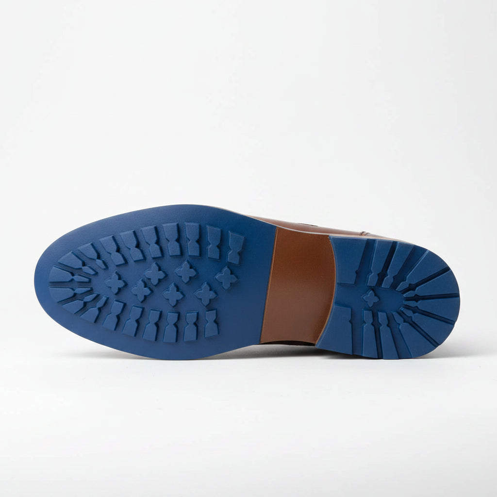 Close-up of a blue shoe sole with a brown rubber patch on a white background
