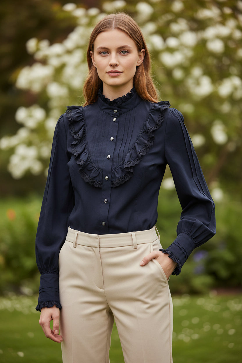 Black blouse with ruffled shoulders and cuffs on a white background