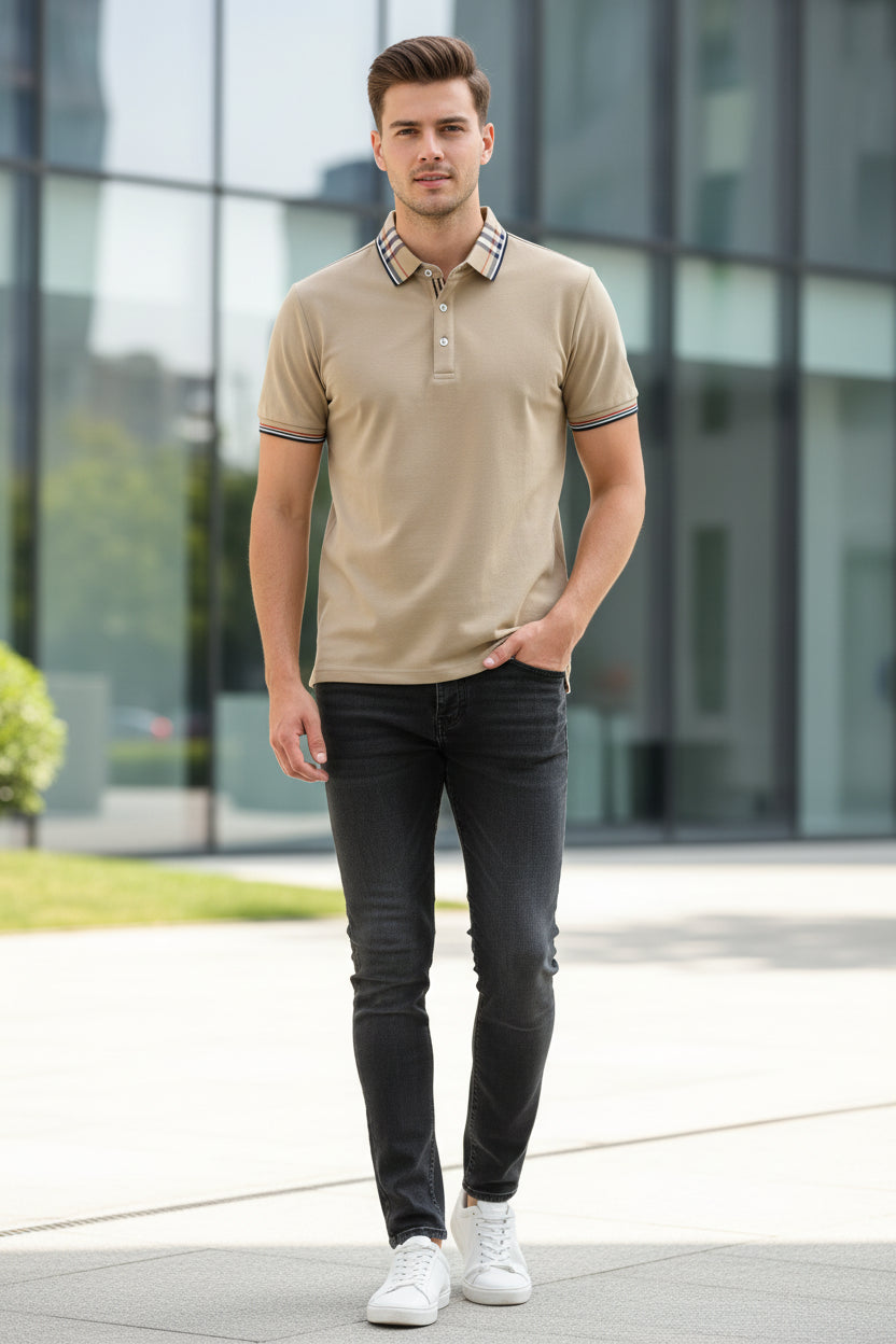 Beige polo shirt with plaid collar held by a hand, brand visible on label.