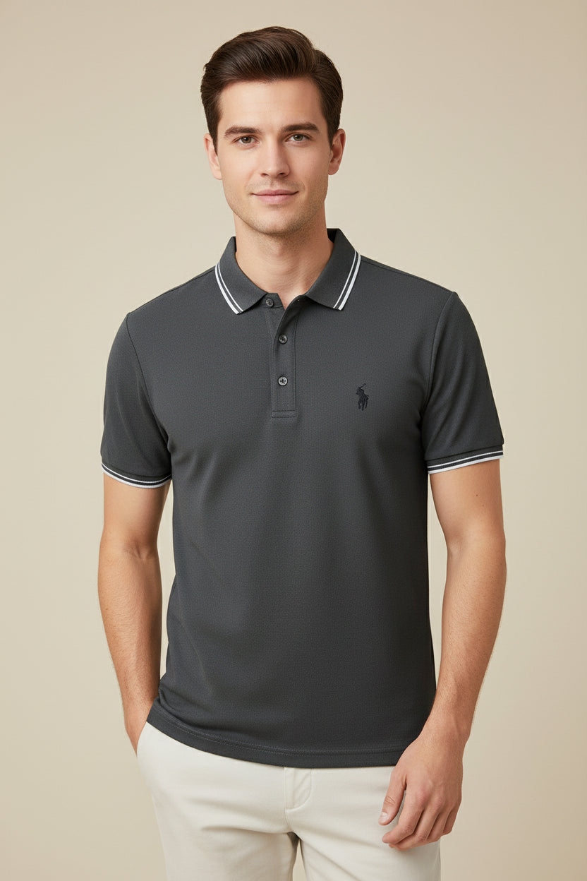 Dark gray polo shirt with white trim on a rack with other shirts in the background