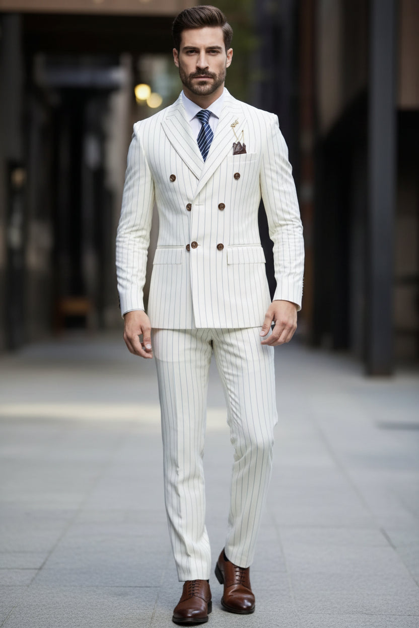 Man wearing a white pinstripe suit with a tie and pocket square against a dark background