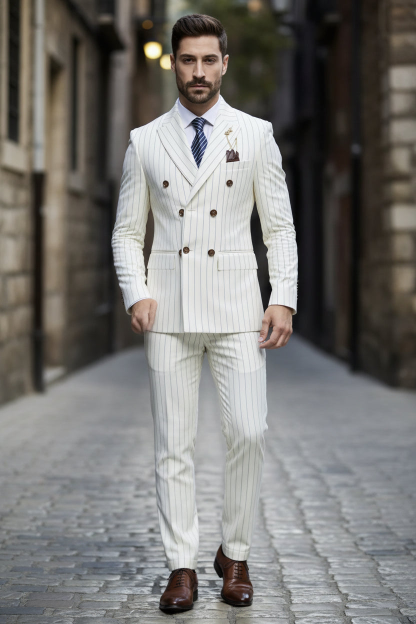 Man wearing a white pinstripe suit with a tie and pocket square against a dark background