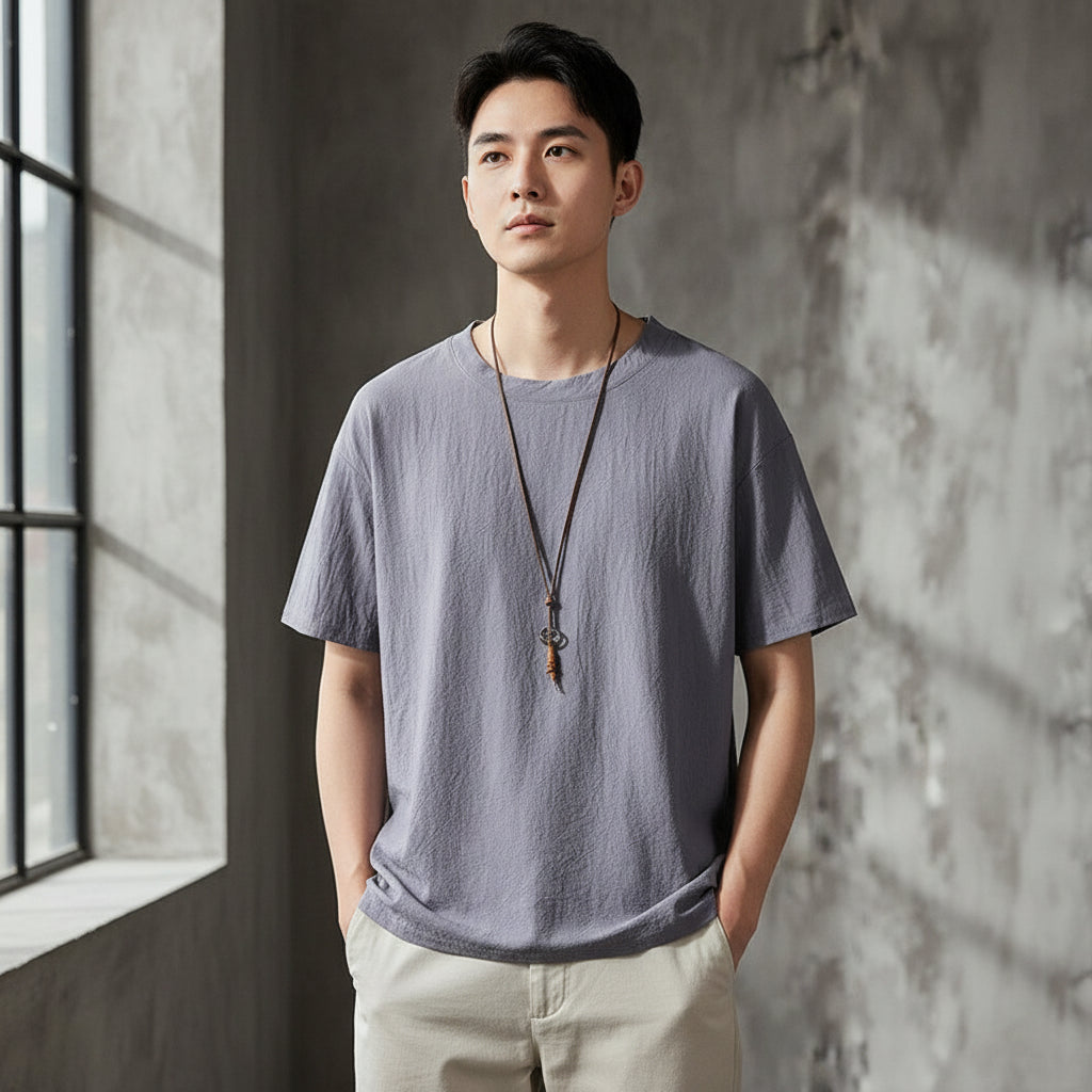 Gray t-shirt on a hanger against a textured gray wall with 'FASHION FOR YOU' text.